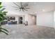 Open living area with modern tile flooring, kitchen with barstool seating at 7732 Bandon Cliffs St, North Las Vegas, NV 89084