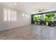 Open living area with modern tile flooring, stylish plants, and large windows at 7732 Bandon Cliffs St, North Las Vegas, NV 89084