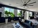 Spacious living room with large windows, plantation shutters, and modern decor at 7732 Bandon Cliffs St, North Las Vegas, NV 89084