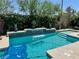Inviting backyard pool with a waterfall feature, perfect for relaxation and entertaining at 7732 Bandon Cliffs St, North Las Vegas, NV 89084