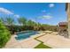 Inviting backyard featuring a modern pool, lush landscaping, and a serene patio area perfect for relaxation at 7732 Bandon Cliffs St, North Las Vegas, NV 89084