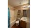 Bathroom featuring a shower-tub combo, vanity with sink, and storage shelving at 7801 Olympus Ave, Las Vegas, NV 89131