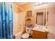 Bathroom with a shower-tub combo and storage shelving for personal items at 7801 Olympus Ave, Las Vegas, NV 89131