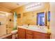Well-lit bathroom features a double sink vanity, large mirror, and a convenient glass door shower at 7801 Olympus Ave, Las Vegas, NV 89131