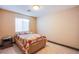 Simple bedroom with a cozy quilt, side table, and tiled flooring at 7801 Olympus Ave, Las Vegas, NV 89131