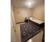 Cozy bedroom with neutral walls, a single bed and a patterned area rug at 7801 Olympus Ave, Las Vegas, NV 89131