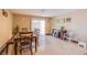 Bright dining area with tile flooring, table with chairs and a sliding glass door at 7801 Olympus Ave, Las Vegas, NV 89131