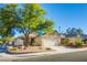 Charming single story home with a two car garage, desert landscaping, and a spacious driveway at 7801 Olympus Ave, Las Vegas, NV 89131
