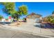 Single story home with desert landscaping, large driveway, and a two-car garage on a corner lot at 7801 Olympus Ave, Las Vegas, NV 89131