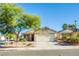 Charming single story home with a two car garage, desert landscaping, and a spacious driveway at 7801 Olympus Ave, Las Vegas, NV 89131