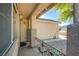 A close up of a quaint front porch with a decorative metal railing leads to the front door at 7801 Olympus Ave, Las Vegas, NV 89131