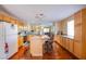 Bright kitchen featuring an island with seating, wood floors, and stainless steel appliances at 7801 Olympus Ave, Las Vegas, NV 89131