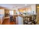 An open kitchen featuring wood cabinets, a breakfast bar, tile backsplash, and stainless appliances at 7801 Olympus Ave, Las Vegas, NV 89131