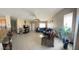 Spacious living room featuring tile floors, a ceiling fan, and a comfortable seating area at 7801 Olympus Ave, Las Vegas, NV 89131