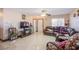 Open living room featuring tile flooring, large window for natural light, and comfortable seating arrangement at 7801 Olympus Ave, Las Vegas, NV 89131