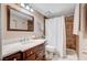 Bathroom featuring a marble vanity countertop and tiled shower with white shower curtain at 7952 Diamond Rock Way # 102, Las Vegas, NV 89128
