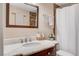 Bathroom featuring a marble vanity countertop and tiled shower with white shower curtain at 7952 Diamond Rock Way # 102, Las Vegas, NV 89128