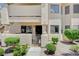 Close up of the front entrance to the condo, featuring a gated entry, security door, and well kept yard at 7952 Diamond Rock Way # 102, Las Vegas, NV 89128