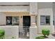 A ground floor condo entrance with gated access, providing security and charm with manicured bushes at 7952 Diamond Rock Way # 102, Las Vegas, NV 89128