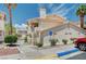Exterior of a multi-unit building featuring private entrances, light stucco, tile roof, and desert landscaping at 7952 Diamond Rock Way # 102, Las Vegas, NV 89128