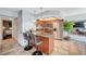 Kitchen boasts an island breakfast bar, light wood cabinets and flooring and stainless steel appliances at 7952 Diamond Rock Way # 102, Las Vegas, NV 89128