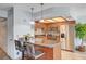 Kitchen features a breakfast bar, stainless steel appliances, granite counters, and tile backsplash at 7952 Diamond Rock Way # 102, Las Vegas, NV 89128