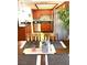 Cozy kitchen featuring wood cabinets, stainless steel appliances, and charming dining table setup at 7952 Diamond Rock Way # 102, Las Vegas, NV 89128