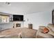 Spacious living room with stone fireplace and mounted television at 7952 Diamond Rock Way # 102, Las Vegas, NV 89128