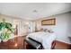 Comfortable main bedroom with wood floors, bench, and access to bathroom at 7952 Diamond Rock Way # 102, Las Vegas, NV 89128