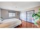 Serene main bedroom featuring wood floors, ample closet space, and natural light at 7952 Diamond Rock Way # 102, Las Vegas, NV 89128