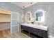 Elegant bathroom with double sinks, modern lighting, wood floors and walk in closet at 81 Alerion St, Las Vegas, NV 89138