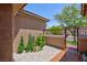 Charming front entrance with decorative iron gate, landscaped garden, and a walkway leading to the home at 81 Alerion St, Las Vegas, NV 89138