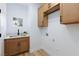 Efficient laundry area featuring upper cabinets, stainless sink, and bright, natural lighting at 81 Alerion St, Las Vegas, NV 89138