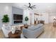 Bright living room with sleek fireplace, large TV, modern ceiling fan, and stylish, contemporary decor at 81 Alerion St, Las Vegas, NV 89138