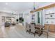 An open-concept living room with a fireplace, modern decor, and a dining area with a wine rack at 81 Alerion St, Las Vegas, NV 89138