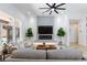 Bright living room with a fireplace, large windows, modern decor, and a contemporary ceiling fan at 81 Alerion St, Las Vegas, NV 89138