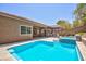 Beautiful backyard featuring a pool and outdoor kitchen area under a modern pergola at 81 Alerion St, Las Vegas, NV 89138