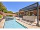 Inviting backyard oasis with a sparkling pool, relaxing spa, and shaded outdoor kitchen area at 81 Alerion St, Las Vegas, NV 89138