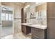 Bathroom with dual sink vanity, custom cabinetry, and decorative backsplash at 8113 Gothic Ave, Las Vegas, NV 89117