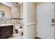 Neutrally decorated bathroom with tiled walls, a toilet, a sink, and an entry door at 8113 Gothic Ave, Las Vegas, NV 89117