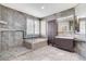 Neutral bathroom with a tiled shower and a soaking tub, window and cabinet storage at 8113 Gothic Ave, Las Vegas, NV 89117