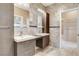 Bathroom featuring double vanity sinks, wall mirror, and tile backsplash at 8113 Gothic Ave, Las Vegas, NV 89117