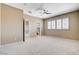 Spacious carpeted bedroom with shuttered windows and en-suite bath at 8113 Gothic Ave, Las Vegas, NV 89117