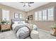 Comfortable bedroom with neutral tones, and bright, shuttered windows at 8113 Gothic Ave, Las Vegas, NV 89117