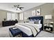 Primary bedroom with a neutral color palette, a ceiling fan, and plantation shutters at 8113 Gothic Ave, Las Vegas, NV 89117