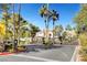 Gated community entrance with lush landscaping and mature palm trees creating an inviting curb appeal at 8113 Gothic Ave, Las Vegas, NV 89117
