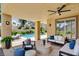 Inviting covered patio with stylish seating area, ceiling fan, and view of the refreshing pool at 8113 Gothic Ave, Las Vegas, NV 89117