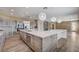 Gorgeous open kitchen with expansive island, pendant lighting, and stainless steel appliances at 8113 Gothic Ave, Las Vegas, NV 89117