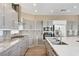 Well-equipped kitchen with granite countertops, stainless steel appliances and grey cabinets at 8113 Gothic Ave, Las Vegas, NV 89117
