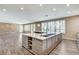 Open kitchen and living space with large island and wood-look floors at 8113 Gothic Ave, Las Vegas, NV 89117